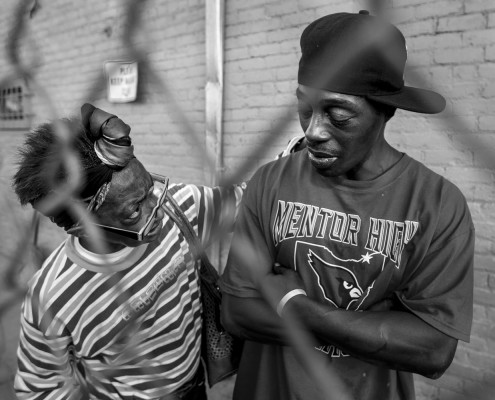 A woman tries to convince a heavily intoxicated man who was standing outside the Neighborhood Service Organization (NSO) to go inside and sober up.